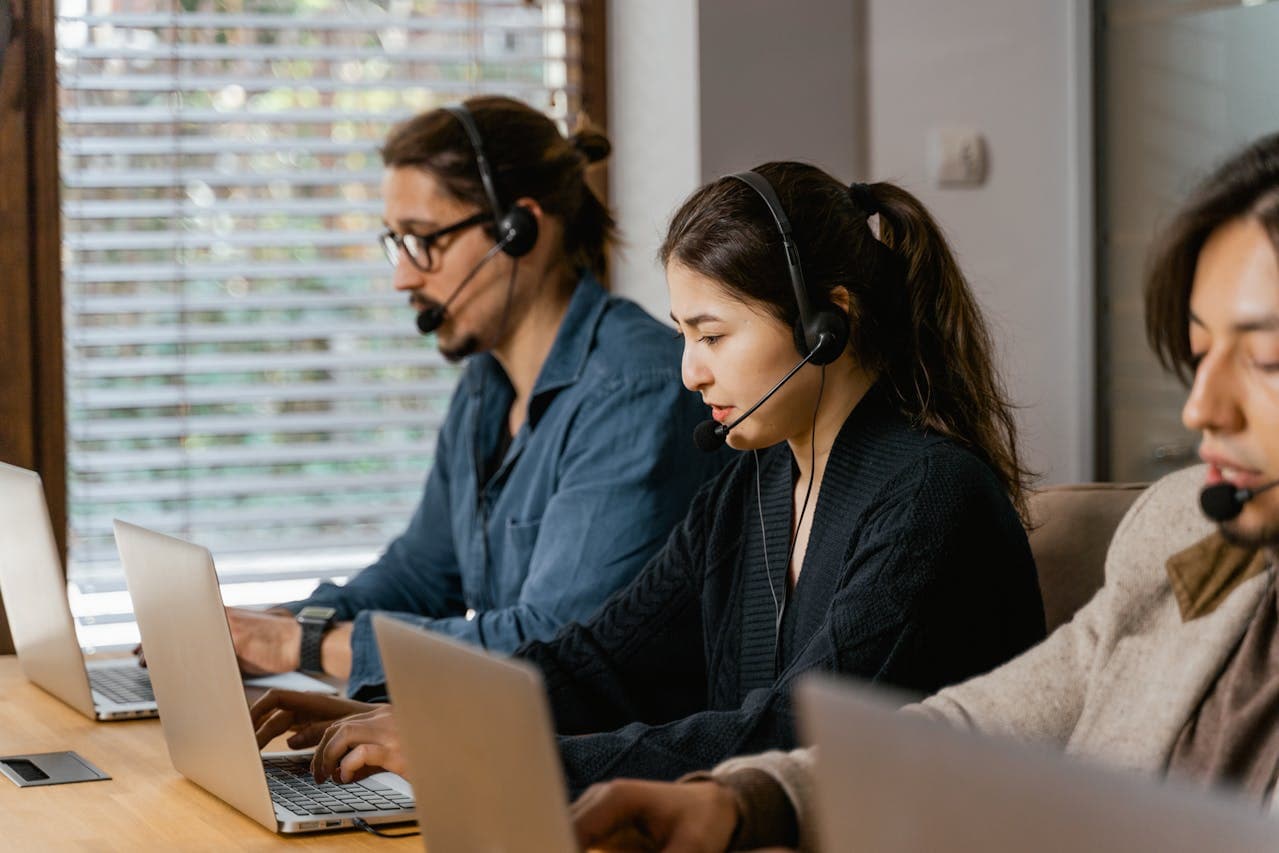 Professional team working on job applications and recruitment technology in modern office environment